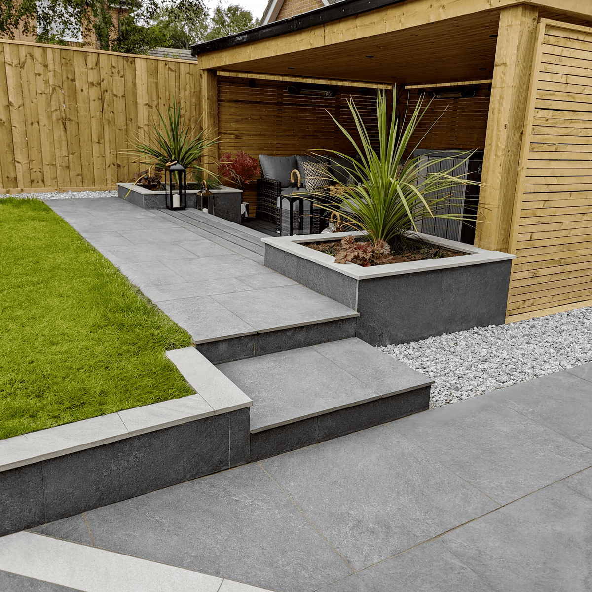 Light porcelain paving and a sheltered outdoor seating area